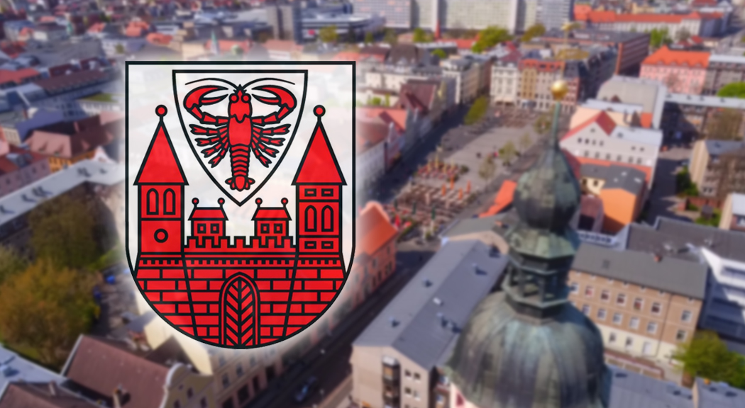 Die Drohnenaufnahme zeigt Cottbus von oben. Das Wappen ist eingefügt.