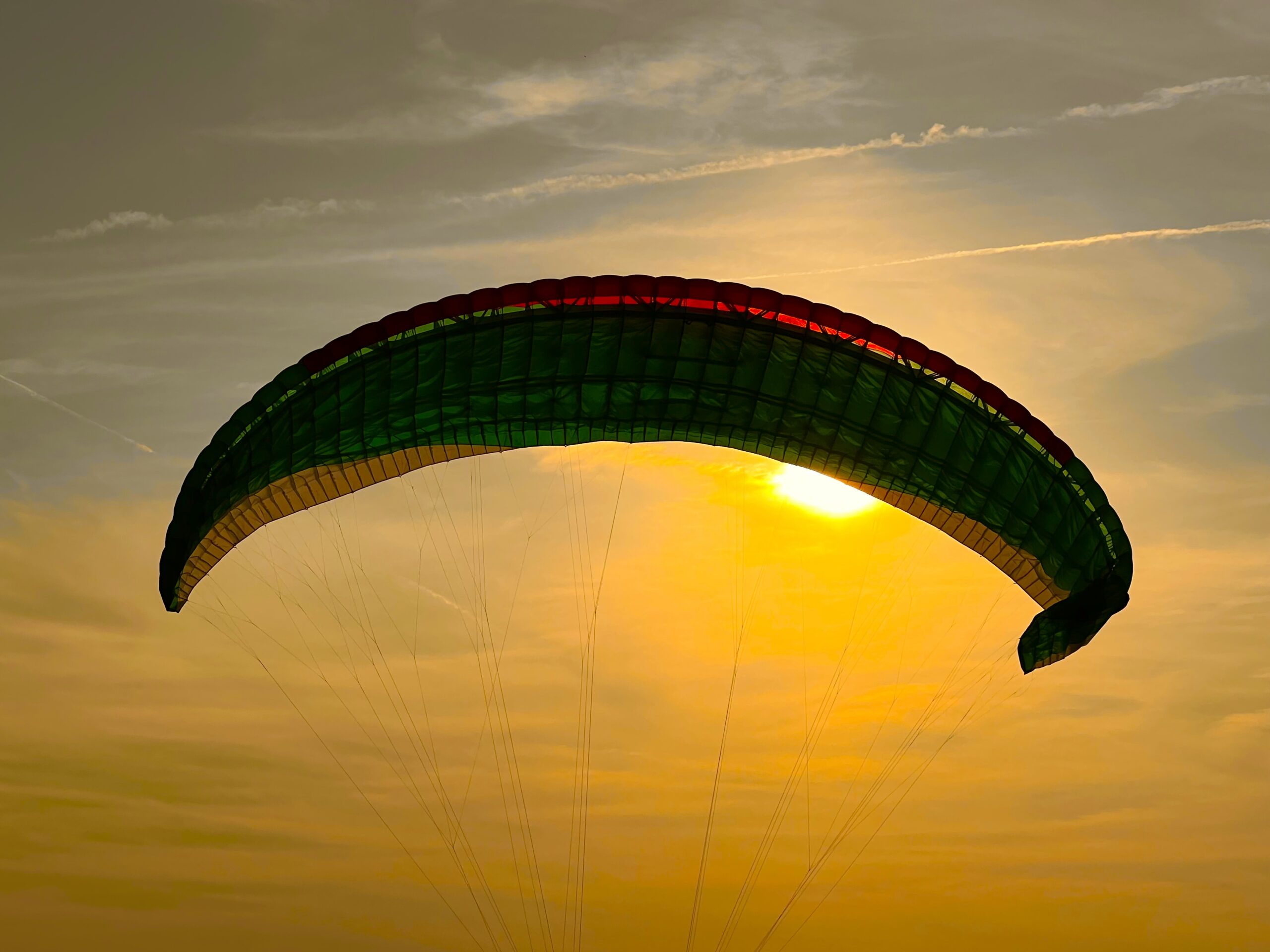 Ein Gleitschirm im Flug bei Sonnenuntergang.